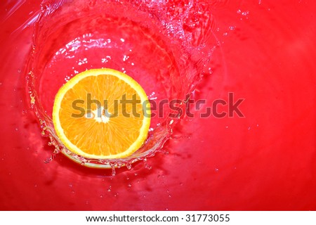 orange is falling in water