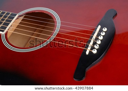 red acoustic guitar with copper strings