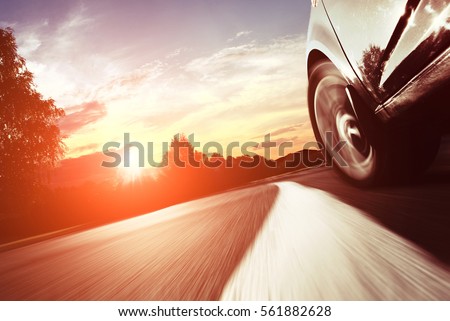 The car moves at fast speed at the night. Blured road with lights with car on high speed