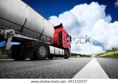 Big metal fuel tanker truck shipping fuel against blue sky