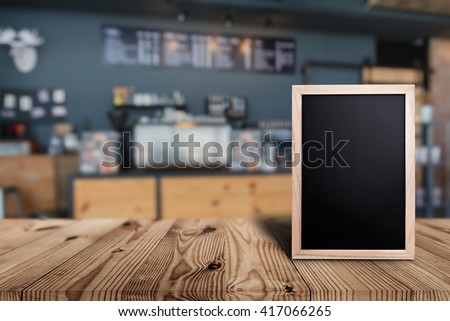 Blank menu board on wooden top table with blurred of coffee shop background