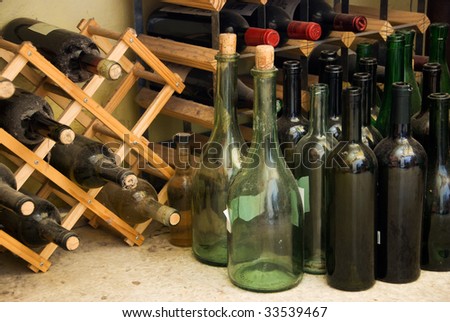 Wine bottles on floor and on wine rack