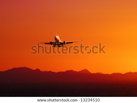 Picture of a plane taking off at sunset