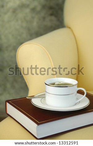 Cup of tea and book on chair