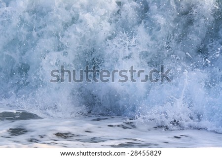 Blue surge of Mediterranean Sea; There are foam and many splashes.