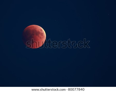 Lunar eclipse 15.06.2011. Red disc of moon over dark sky.
