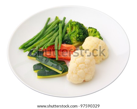 steamed vegetables of yellow, green and orange colors on white round dish isolated over white background. Side view. - stock photo