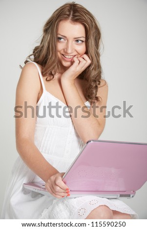 smiling girl with a pink computer