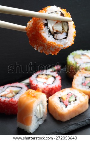 Japanese sushi and rolls on a dark background