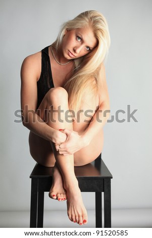 beautiful girl posing sitting on a stool
