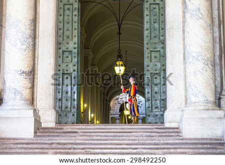 VATICAN, VATICAN CITY - MAY 2, 2015 : Swiss guard in a Vatican building entrance. The  Swiss Guard is responsible for the personal security of the Pope and resident in the state of Vatican.