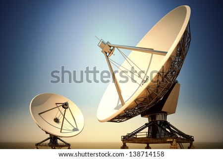 Two big satellite dishes aimed into space. Parabolic antennas in twilight.