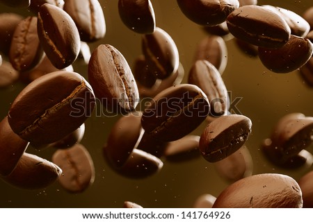 Brown roasted coffee beans falling. Dark background. May represent breakfast, energy, freshness or great aroma.