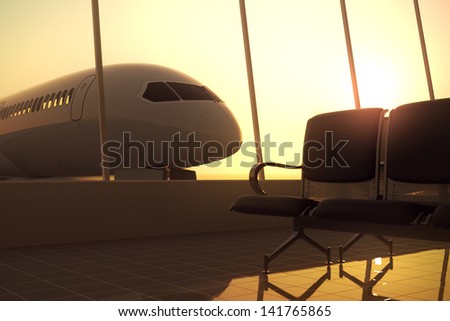 Modern airport terminal with black leather seats at sunset. A huge viewing glass facade with a passenger aircraft behind it.