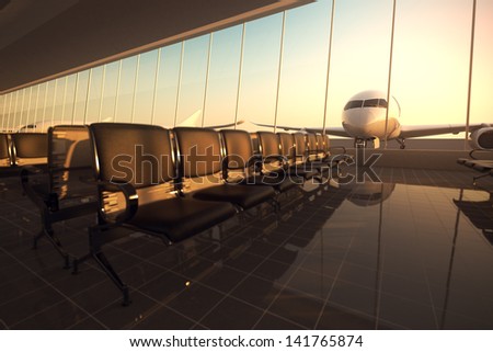 Modern Airport Terminal With Black Leather Seats At Sunset. A Huge Viewing Glass Facade With A Passenger Aircraft Behind It.