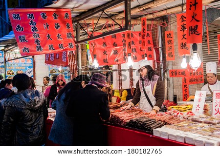 TAIPEI - JAN. 25: unidentified street vendors helping customers buying new year candy at Dihua Street-- the oldest New Year\'s Market street in Taipei , January 25th, 2014 in Taipei,Taiwan.