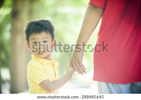 Father and son holding hand in hand