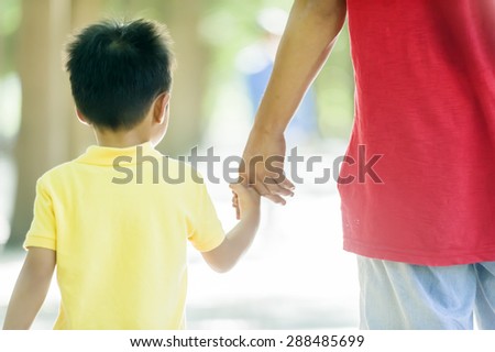 Father and son holding hand in hand