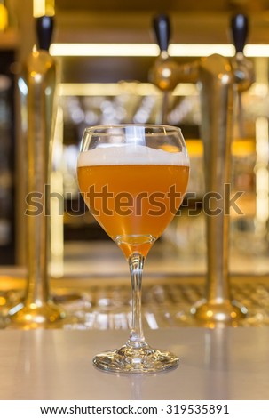 Beer Taps at Bar with full glass