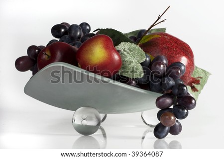 Glass bowl with fruits on a white background