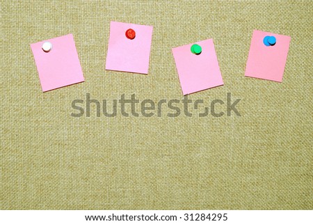 Board with pined notepads for messages.