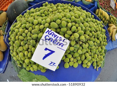 green apricots at the market