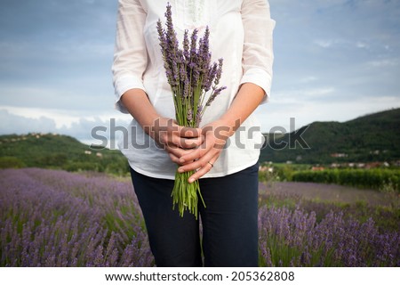 Woman holding lavender flowers bouquet