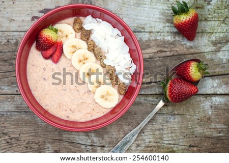 Trendy porridge decorated with fruits and coconut chips