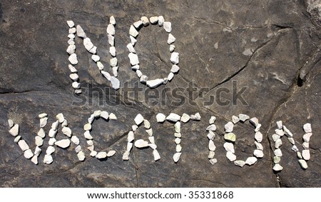 NO VACATION inscription on the sea shore