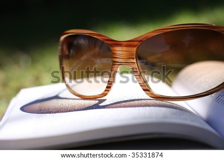 Sun glasses on the open book