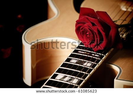 Red rose on jazz guitar