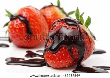Strawberries with liquid chocolate, isolated on white