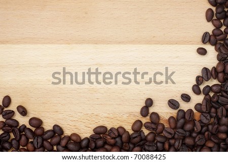 Coffee beans border  on wooden desk with copyspace
