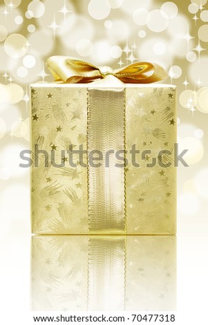 Golden box gift against bokeh background