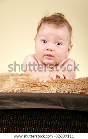 Adorable baby boy on fur blanket