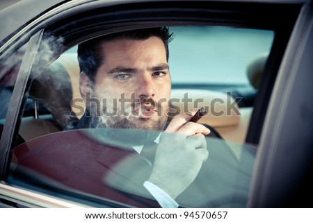 Wealthy man in the back seat of a car