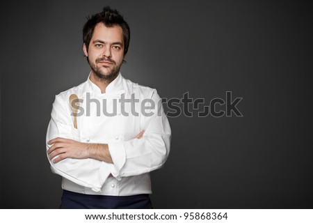 Handsome chef posing against gray background Handsome chef posing against gray background