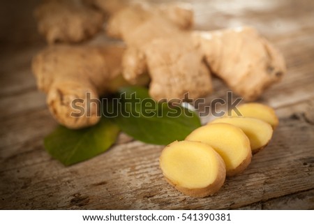 Ginger root slices on rustical wooden table