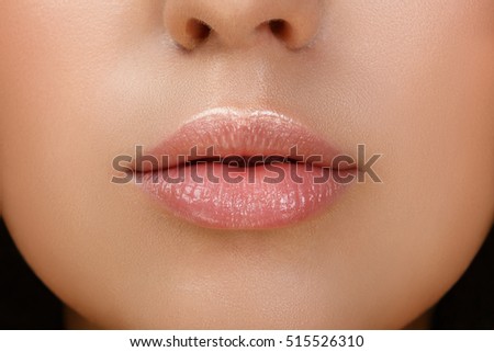 Perfect natural lip makeup. Close up macro photo with beautiful female mouth. Plump full lips. Close-up face detail. Perfect clean skin, light fresh lip make-up. Beautiful spa tender lip