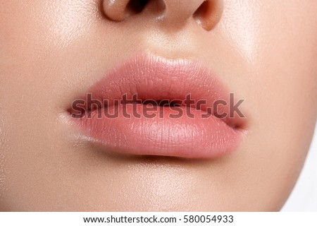Perfect natural lip makeup. Close up macro photo with beautiful female mouth. Plump full lips.