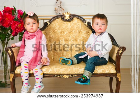 The image of brother and sister sitting on the couch
