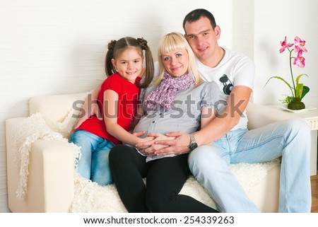 The image of a happy family expecting the second child