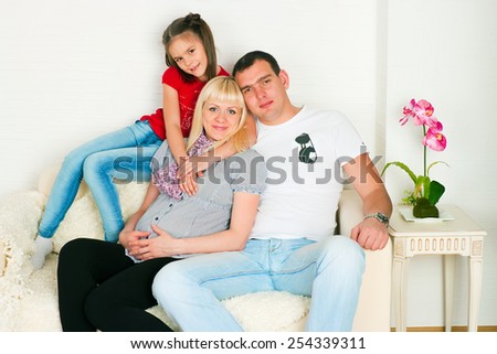 The image of a happy family expecting the second child