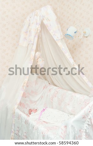 The newborn child in a bed with a canopy