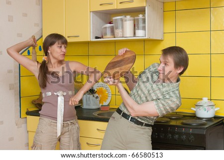 The image of the woman beating the man on kitchen