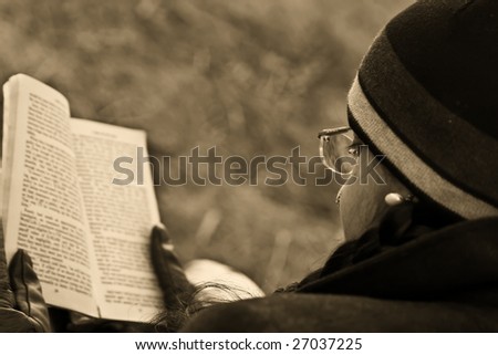 Reading outdoor beside a lake at sunset nice pass time with nature.