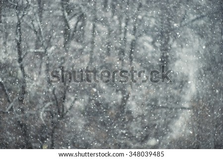 Falling snow. Storm. Dark abstract christmas winter theme. Unfocused. Vintage effect.