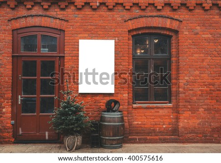 Brick wall restaurant facade with window, entrance, christmas decor and blank space for menu poster.