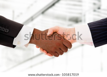 Business team shaking hands while in their office
