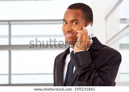 African American smiling businessman on the phone in his office